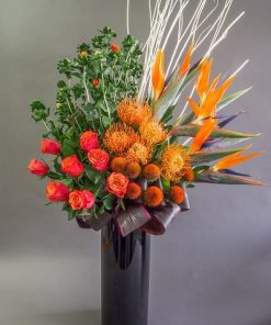 roses and pin cushion black vase arrangement